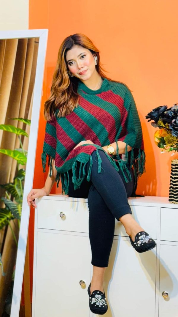 Toropy Premium winter poncho . Latest Designer Clothing for Women's and girl's. No 1 Premium Women's and Girls's Clothing Brand In bangladesh . WOOL Fabrics . Winter Friendly Dress. এই উলের পঞ্চটি শীতের ঠান্ডা থেকে আপনাকে উষ্ণ রাখবে। এর নরম টেক্সচার আপনাকে আরামদায়ক অনুভূতি দেবে। সাধারণ ডিজাইনের এই পঞ্চটি আপনার দৈনন্দিন পোশাকের সাথে সহজেই মানিয়ে নেবে। পঞ্চটি আপনাকে শীতের ফ্যাশন ট্রেন্ডে এগিয়ে রাখবে। এর সুন্দর ডিজাইন আপনাকে বিশেষ করে তুলবে। এই পঞ্চটি শুধু আপনাকে উষ্ণ রাখবে না, আপনার স্টাইলকেও আরও উজ্জ্বল করবে। নরম কাপড় এবং ফ্যাশনেবল ডিজাইন আপনাকে দিনভর আরামদায়ক রাখবে। উষ্ণ, আরামদায়ক, স্টাইলিশ, নরম, হালকা ওজন, দীর্ঘস্থায়ী, ফ্যাশনেবল, ঐতিহ্যবাহী, হাতে বোনা, উল, ক্যাশ্মির, ফ্লিস, এক্রিলিক, শীত, তুষার, ঠান্ডা